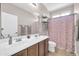 Bathroom features a dual sink vanity, framed mirror, and separated shower/toilet area at 11952 W Villa Chula Ln, Sun City, AZ 85373