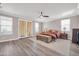 Spacious Primary bedroom features a ceiling fan and balcony access at 11952 W Villa Chula Ln, Sun City, AZ 85373