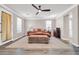 Primary bedroom featuring a ceiling fan and two large windows at 11952 W Villa Chula Ln, Sun City, AZ 85373
