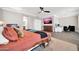 Spacious bedroom featuring TV, ceiling fan, and doorway to bath at 11952 W Villa Chula Ln, Sun City, AZ 85373