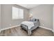 Comfortable bedroom features wood-look floors, a ceiling fan, and bright natural light at 11952 W Villa Chula Ln, Sun City, AZ 85373