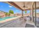 Covered patio with ceiling fan and view of the backyard pool and landscaping at 11952 W Villa Chula Ln, Sun City, AZ 85373