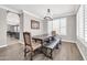 Stylish dining room with a large table, bench, chair and plantation shutters for natural light at 11952 W Villa Chula Ln, Sun City, AZ 85373