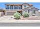 Two-story home featuring a balcony, well-manicured landscaping and a two car garage at 11952 W Villa Chula Ln, Sun City, AZ 85373