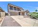 Charming home with a wide driveway, three car garage, and attractive landscaping at 11952 W Villa Chula Ln, Sun City, AZ 85373