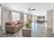 Bright living room featuring a comfortable sofa, modern flooring, and access to an outdoor patio at 11952 W Villa Chula Ln, Sun City, AZ 85373