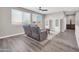 Living area features wood-look floors, bright windows, ceiling fan, and comfortable seating at 11952 W Villa Chula Ln, Sun City, AZ 85373