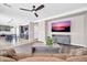 Open-concept living room with ceiling fan, large TV, and an easy flow to the kitchen at 11952 W Villa Chula Ln, Sun City, AZ 85373