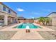 Backyard pool with diving board, surrounded by a patio, desert landscaping, and privacy fence at 11952 W Villa Chula Ln, Sun City, AZ 85373
