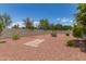 This backyard features gravel landscaping, mature trees, and some stone pavers at 12274 W Monroe St, Avondale, AZ 85323