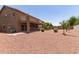 Backyard view featuring a covered patio, drought resistant landscaping and a two-story home at 12274 W Monroe St, Avondale, AZ 85323