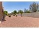 Expansive backyard features gravel landscaping, mature trees, and block wall at 12274 W Monroe St, Avondale, AZ 85323