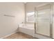 Bright bathroom features a tub and walk-in shower with tiled floors at 12274 W Monroe St, Avondale, AZ 85323
