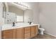 Bathroom featuring dual sinks, modern fixtures, and ample lighting at 12274 W Monroe St, Avondale, AZ 85323