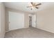 This bedroom features a ceiling fan, a closet with sliding doors, and neutral paint at 12274 W Monroe St, Avondale, AZ 85323