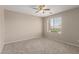 Bedroom features neutral walls, ceiling fan, and a window to outside at 12274 W Monroe St, Avondale, AZ 85323