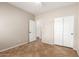 This bedroom features neutral walls, tiled floors and a mirrored door closet at 12274 W Monroe St, Avondale, AZ 85323