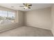 Bedroom with a ceiling fan, window and neutral color paint at 12274 W Monroe St, Avondale, AZ 85323