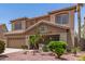 Two-story home featuring desert landscaping, tile roof, and a two-car garage at 12274 W Monroe St, Avondale, AZ 85323