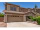 Beige two story house with a well maintained front yard at 12274 W Monroe St, Avondale, AZ 85323