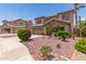 Two-story home featuring desert landscaping, tile roof, and a two-car garage at 12274 W Monroe St, Avondale, AZ 85323