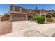 Exterior shot of a two story home with desert landscaping and a two car garage at 12274 W Monroe St, Avondale, AZ 85323