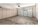 This garage features lots of storage, gray concrete floors, and a white garage door at 12274 W Monroe St, Avondale, AZ 85323