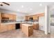 Bright open kitchen featuring stainless steel appliances, granite counters, and light wood cabinetry at 12274 W Monroe St, Avondale, AZ 85323