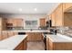 A well lit Kitchen, with stainless steel appliances, granite counters, and light wood cabinetry at 12274 W Monroe St, Avondale, AZ 85323