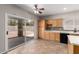 Bright kitchen with light wood cabinets and stainless steel appliances with a large glass sliding door at 12274 W Monroe St, Avondale, AZ 85323