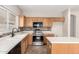 Bright kitchen with stainless steel appliances, tile backsplash, and light cabinets at 12274 W Monroe St, Avondale, AZ 85323