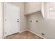 This laundry room features tiled floors and storage cabinets at 12274 W Monroe St, Avondale, AZ 85323