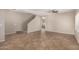 Open living room area with tile flooring and stairs leading up to the second floor at 12274 W Monroe St, Avondale, AZ 85323