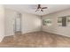 Neutral living room featuring tile flooring, a ceiling fan, and a bright window at 12274 W Monroe St, Avondale, AZ 85323