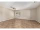Neutral living room featuring tile flooring, a ceiling fan, and a bright window at 12274 W Monroe St, Avondale, AZ 85323