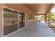 This covered patio features sliding glass doors and views of the home's backyard at 12274 W Monroe St, Avondale, AZ 85323