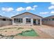 Backyard of home featuring desert landscaping, a small patio area, and clear, sunny skies at 12375 W Whyman Ave, Avondale, AZ 85323