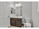 Bathroom with wood vanity, mirror and toilet at 12375 W Whyman Ave, Avondale, AZ 85323