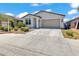 Charming single-Gathering home with desert landscaping and a two-car garage against a blue sky at 12375 W Whyman Ave, Avondale, AZ 85323