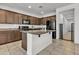 Kitchen with dark wood cabinets, granite counters, tile floors, and stainless appliances at 12375 W Whyman Ave, Avondale, AZ 85323
