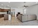Open-concept living room boasts tile floors and flows into the kitchen area at 12375 W Whyman Ave, Avondale, AZ 85323
