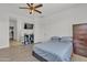Main bedroom features tile flooring, a ceiling fan, and a chest of drawers at 12375 W Whyman Ave, Avondale, AZ 85323