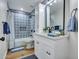 Bathroom with modern vanity, patterned tile, updated lighting, and a shower-tub combination at 12641 S 39Th Pl, Phoenix, AZ 85044