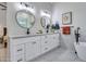 Bathroom with sleek double vanity, modern mirrors, and designer fixtures at 12641 S 39Th Pl, Phoenix, AZ 85044