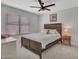 Bedroom with a large bed, ceiling fan, a neutral color palette, and a window that enhances the room's natural light at 12641 S 39Th Pl, Phoenix, AZ 85044