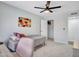 Bedroom with a single bed, a ceiling fan, and closet access, offering a cozy and functional area at 12641 S 39Th Pl, Phoenix, AZ 85044