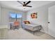Bedroom featuring a single bed, desk, and a window with a view of the outdoors, creating a functional and bright space at 12641 S 39Th Pl, Phoenix, AZ 85044