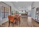 Open dining area features a round table, orange chairs, and a view into the modern kitchen at 12641 S 39Th Pl, Phoenix, AZ 85044