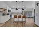 Spacious kitchen with stainless steel appliances, an island with seating, and modern lighting at 12641 S 39Th Pl, Phoenix, AZ 85044