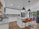Modern kitchen island featuring a breakfast bar, white cabinets, and stainless steel appliances at 12641 S 39Th Pl, Phoenix, AZ 85044